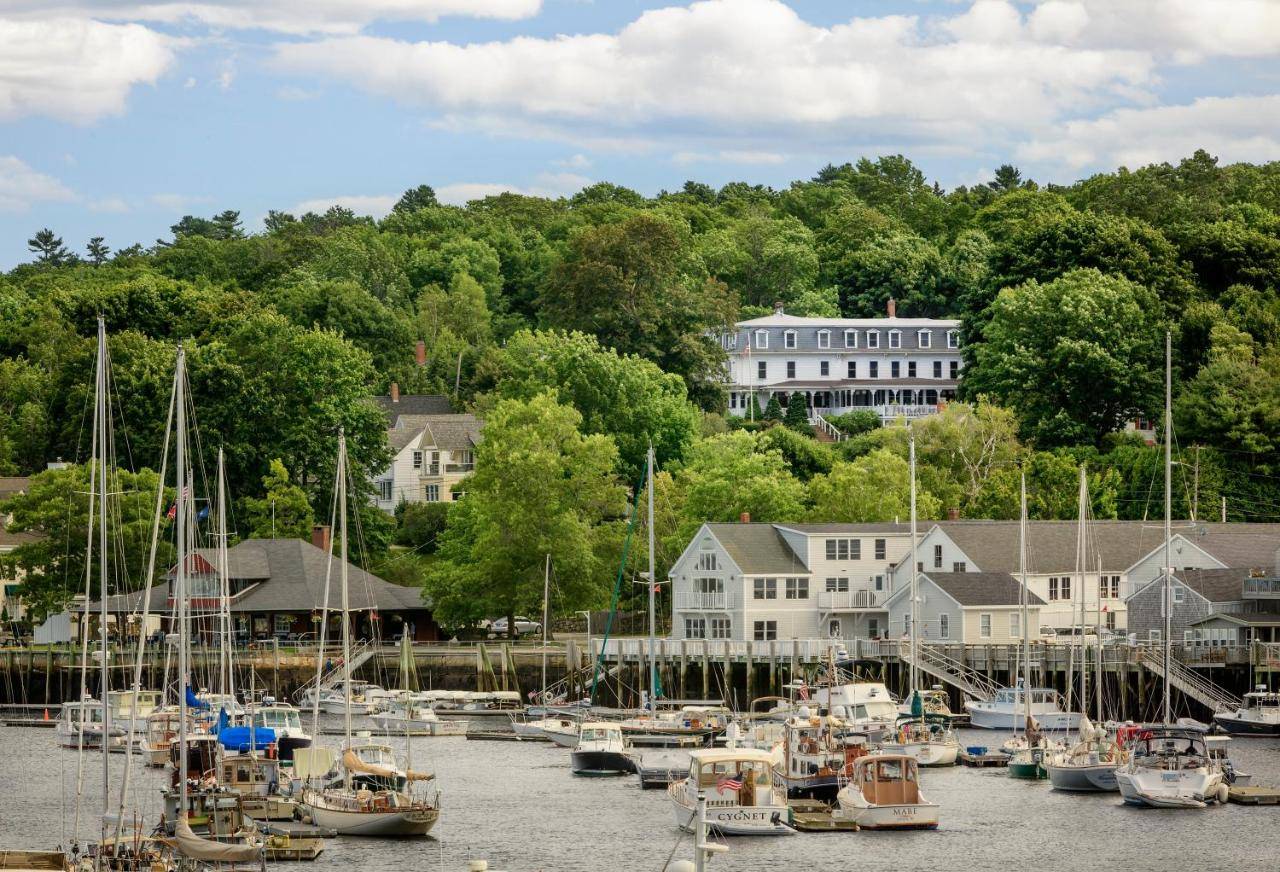 a bunch of boats docked in a harbor with houses at Camden Harbour Inn a member of Small Luxury Hotels in Camden