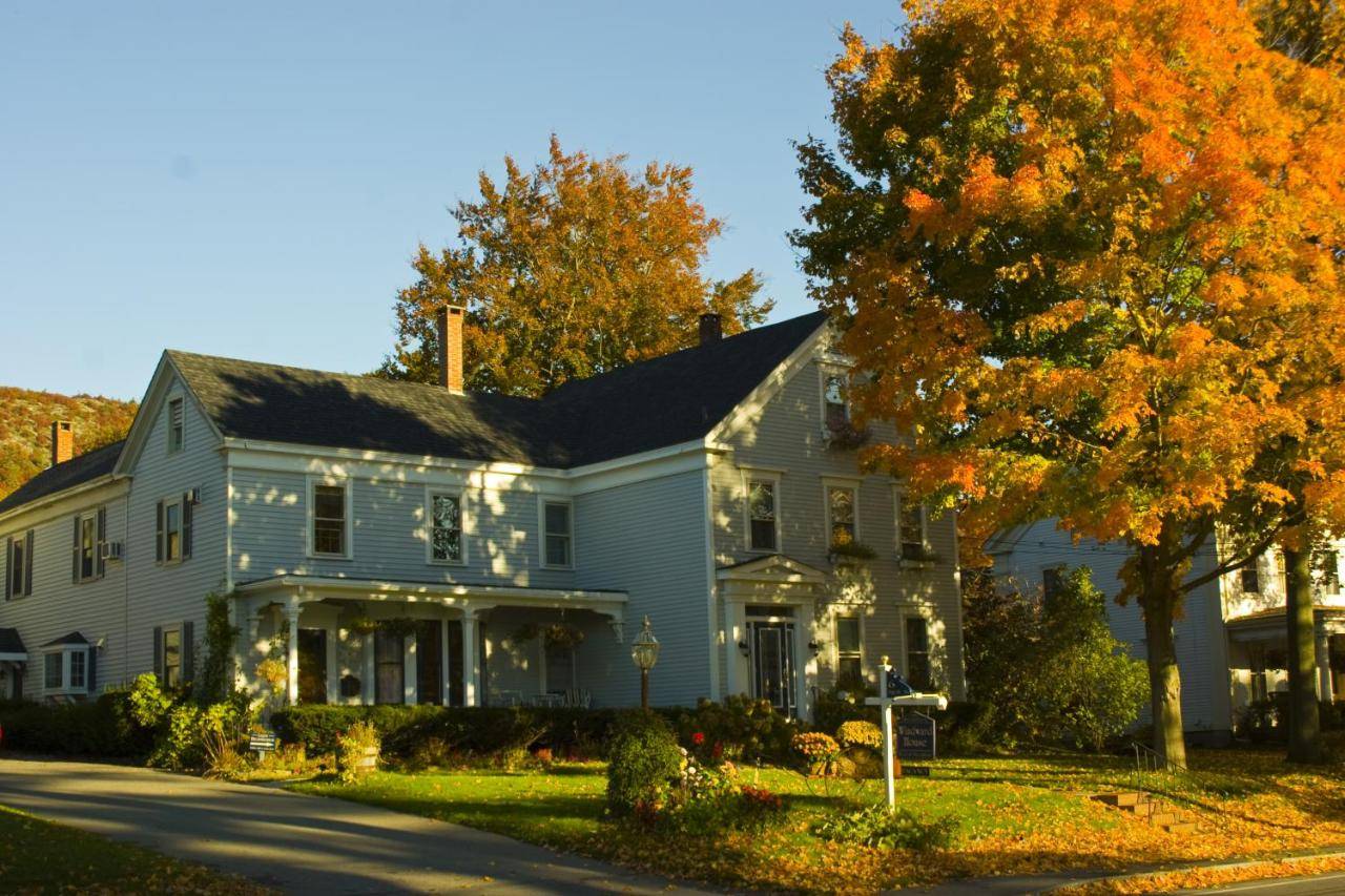 a large white house with a tree in front of it at Camden Windward House in Camden