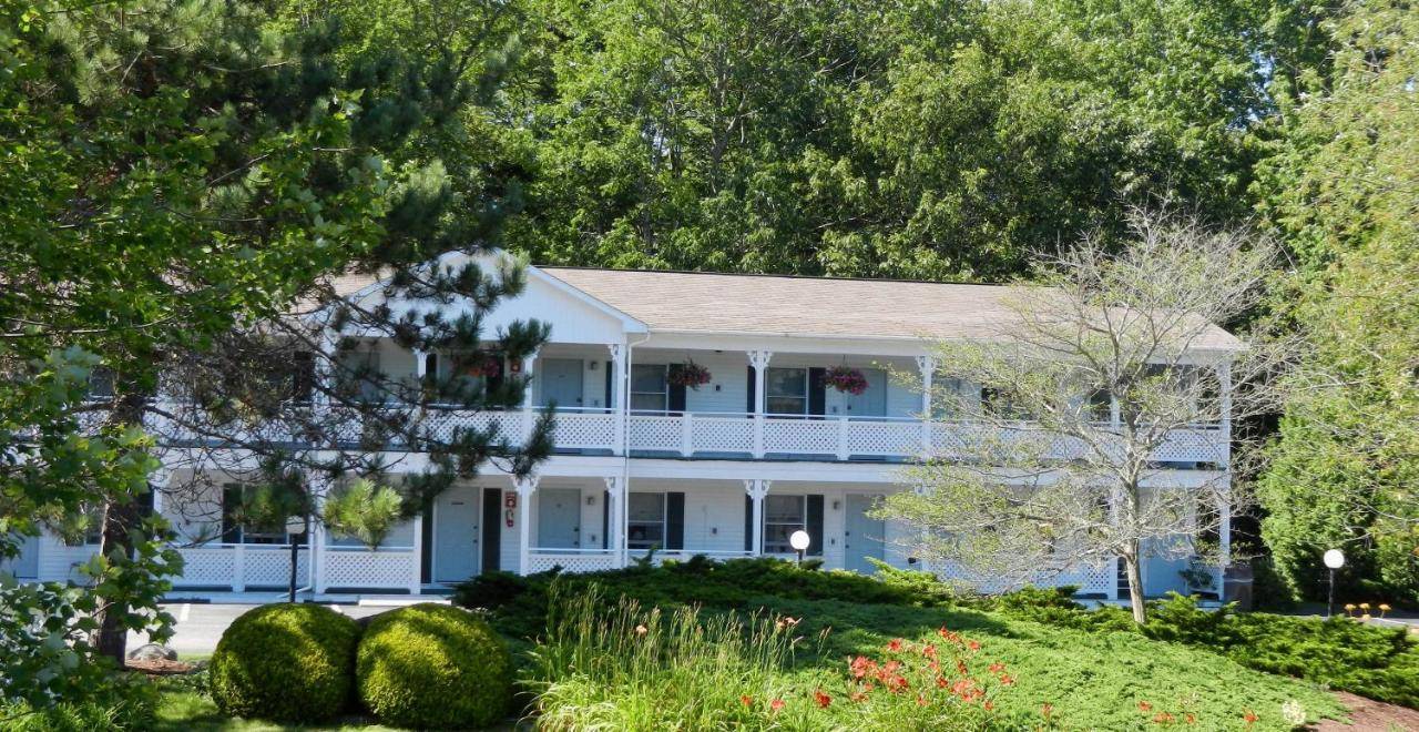 a large white house with a porch at Cedar Crest Inn in Camden