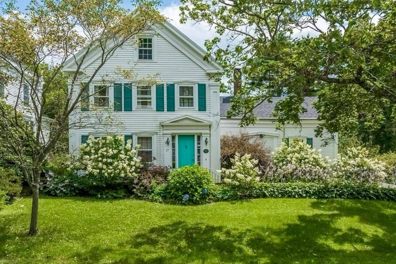 a white house with a blue door and a yard at Seabreeze Manor in Camden
