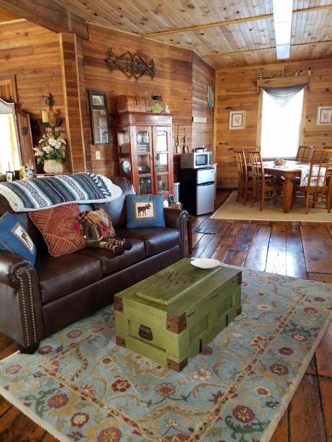 a living room with a couch and a coffee table at The Perkins House in Cornish