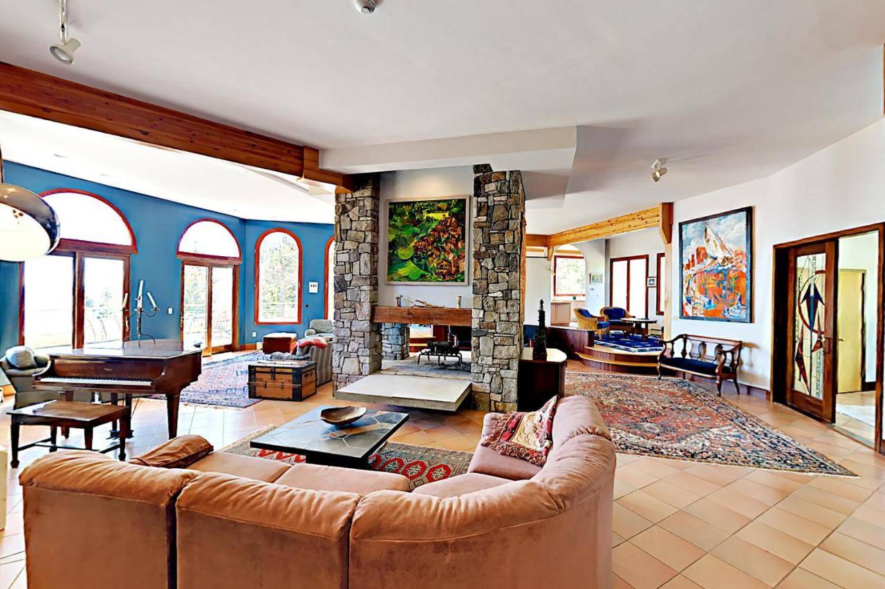 a living room with a couch and a fireplace at Oceanfront Gem in East Boothbay