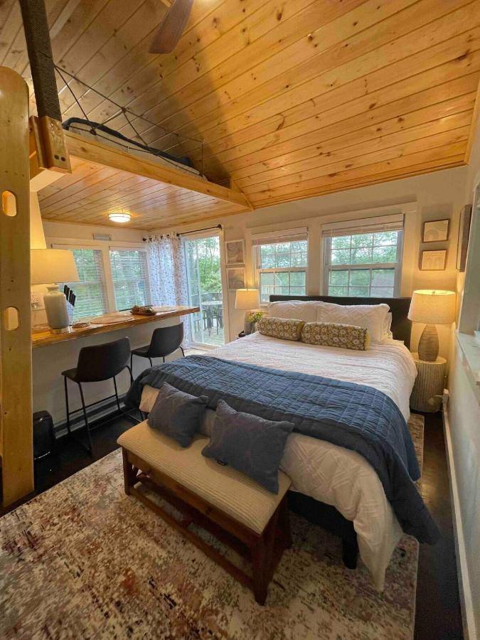 a bedroom with a large bed and a desk at Cheerful Cottage with Loft Close to Everything 6 in Edgecomb