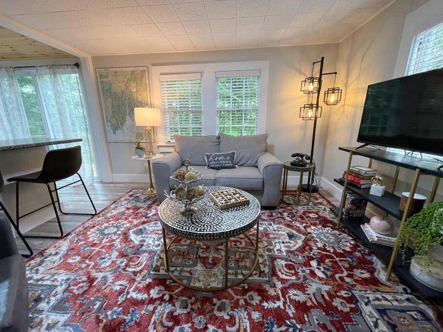 a living room with a couch and a table at Spacious 1 Bedroom Cottage Close to Everything 3 in Edgecomb