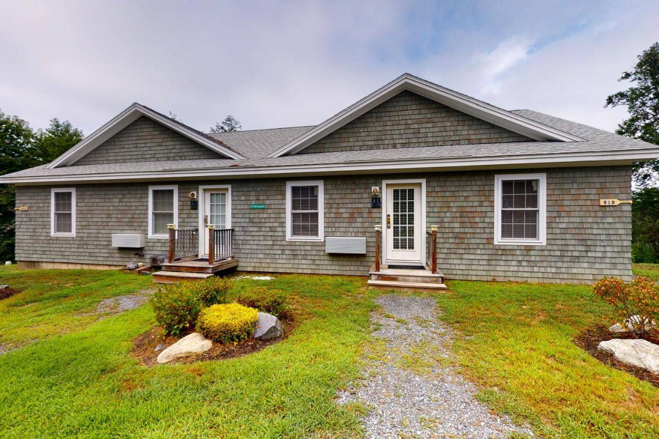 a home with a house with a yard at The View III at Sheepscot River in Edgecomb
