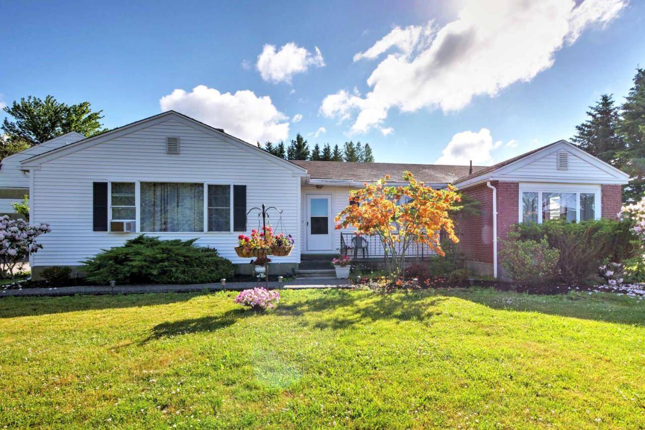 a white house with a yard at Cozy Ellsworth Home with Yard, 15 Mi to Acadia! in Ellsworth