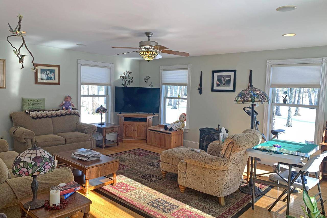 a living room filled with furniture and a flat screen tv at Four Seasons in Ellsworth