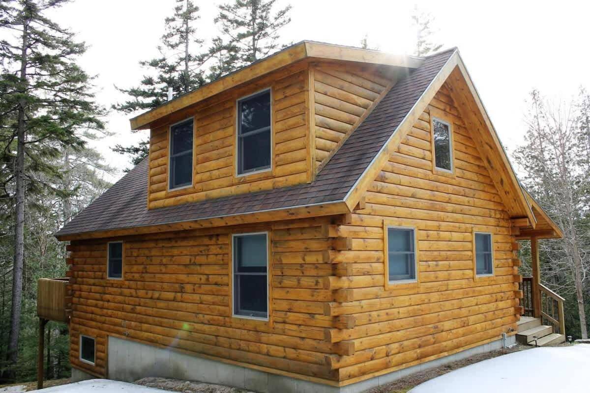a log cabin with a gambrel roof at Log Cabin on Saltwater Cove in Ellsworth