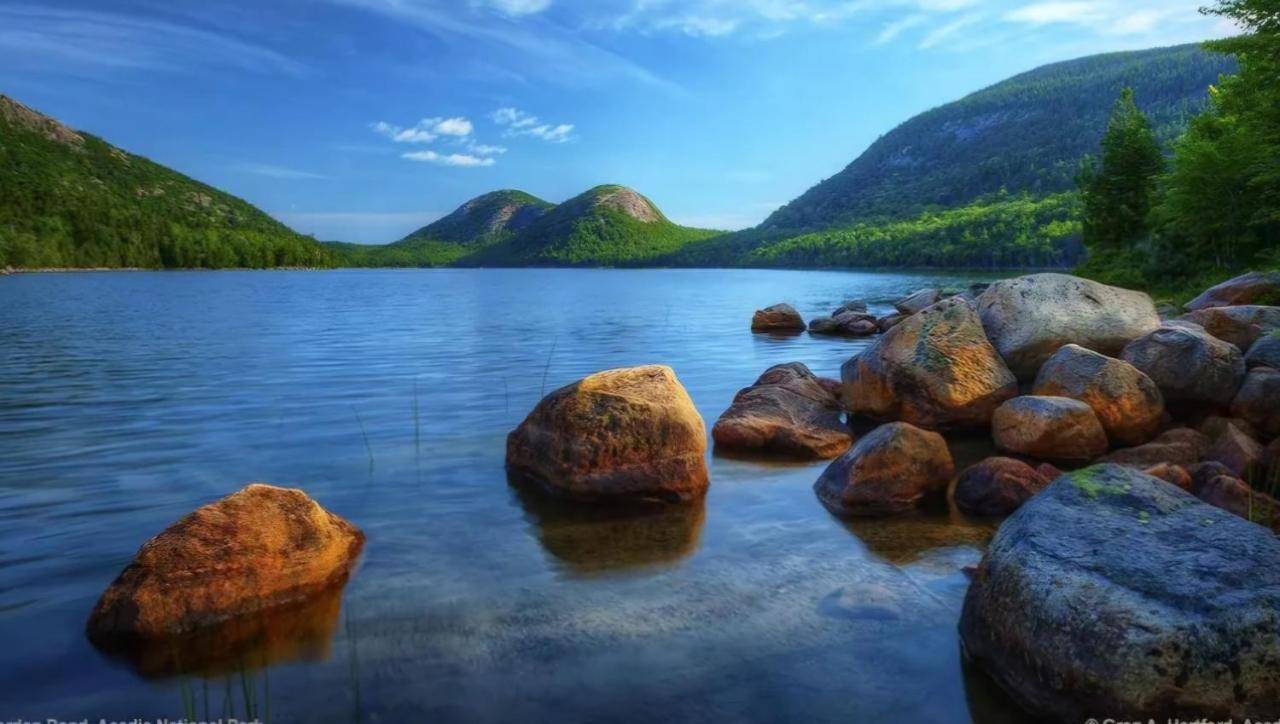 a view of a lake with rocks in the water at One Bed Condo Unit near Acadia National Park in Ellsworth