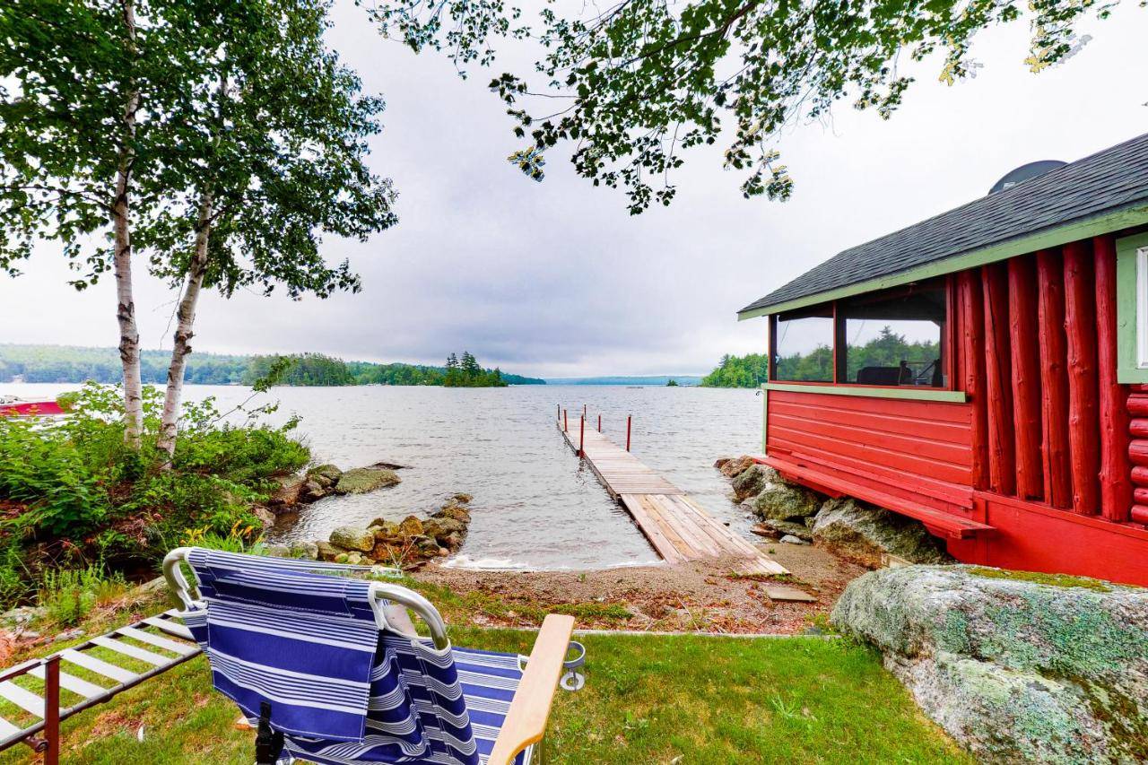 a couple of blue chairs sitting next to a dock at Reece Cottage in Ellsworth