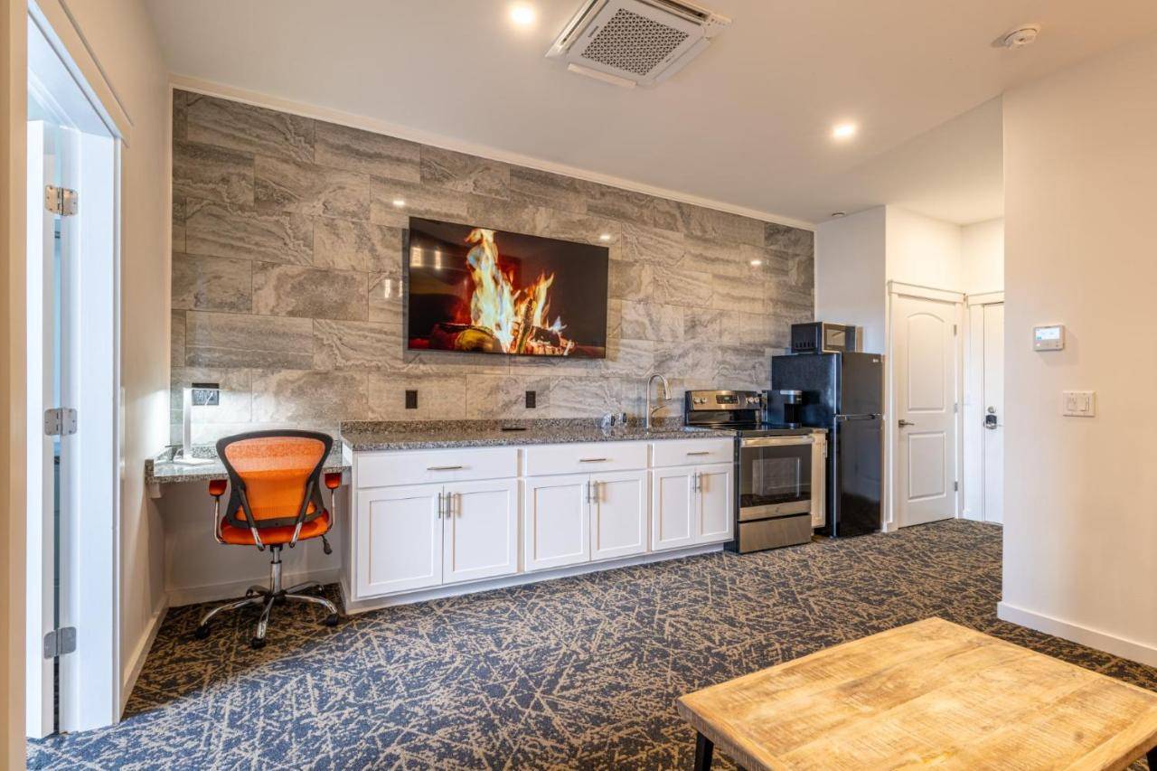 a kitchen with a fire on the wall at Stone Park Ellsworth-Bar Harbor in Ellsworth