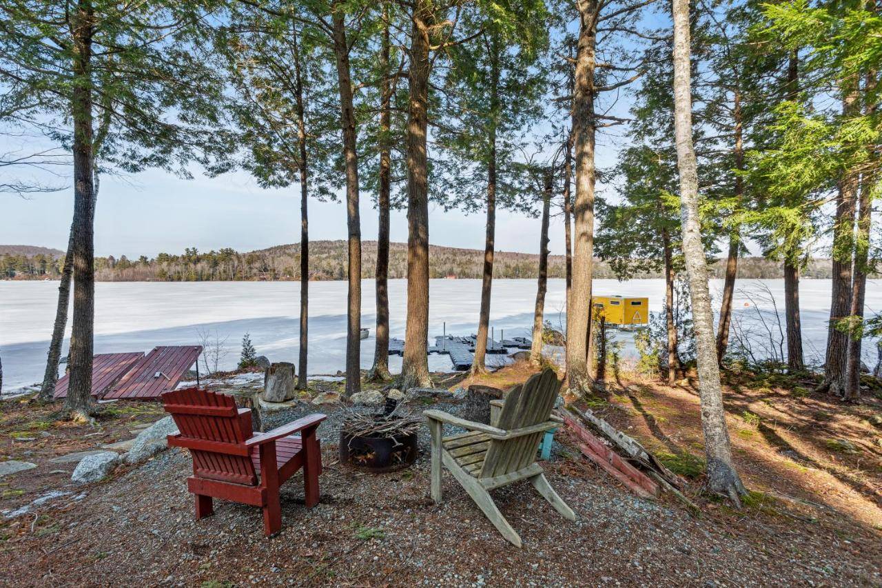 a couple of chairs sitting next to a lake at The Evans House in Ellsworth