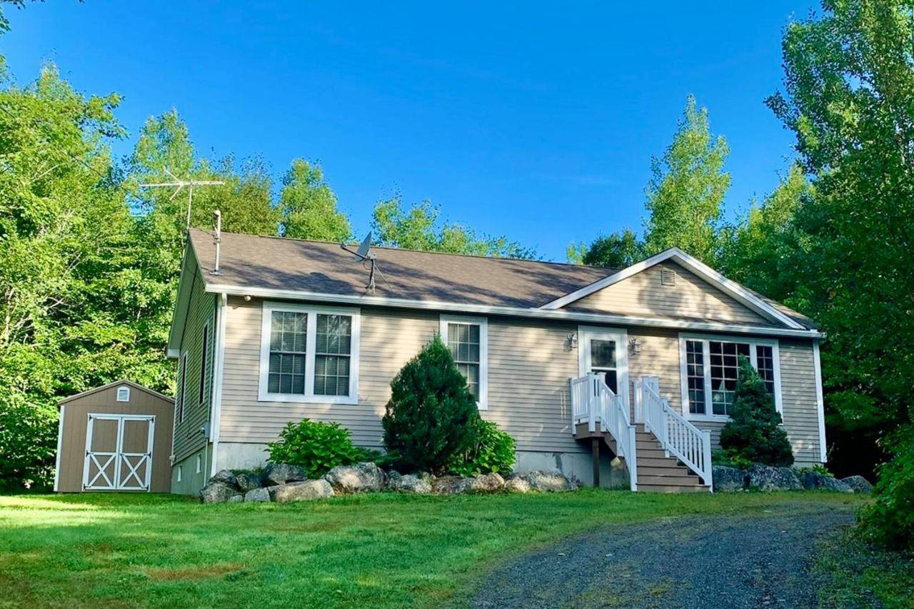 a small house with a porch and a yard at The Winkumpaugh Getaway in Ellsworth