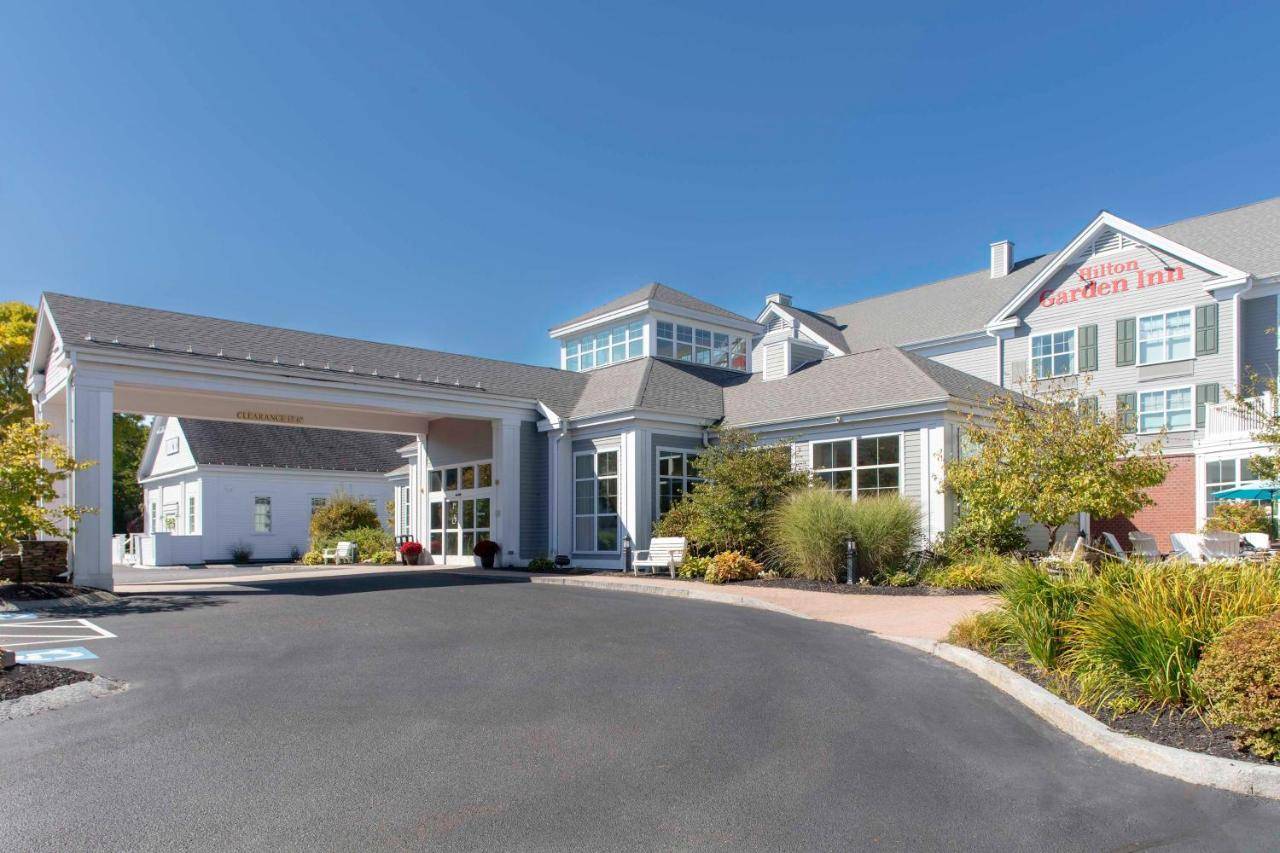 a large house with a driveway in front of it at Hilton Garden Inn Freeport Downtown in Freeport