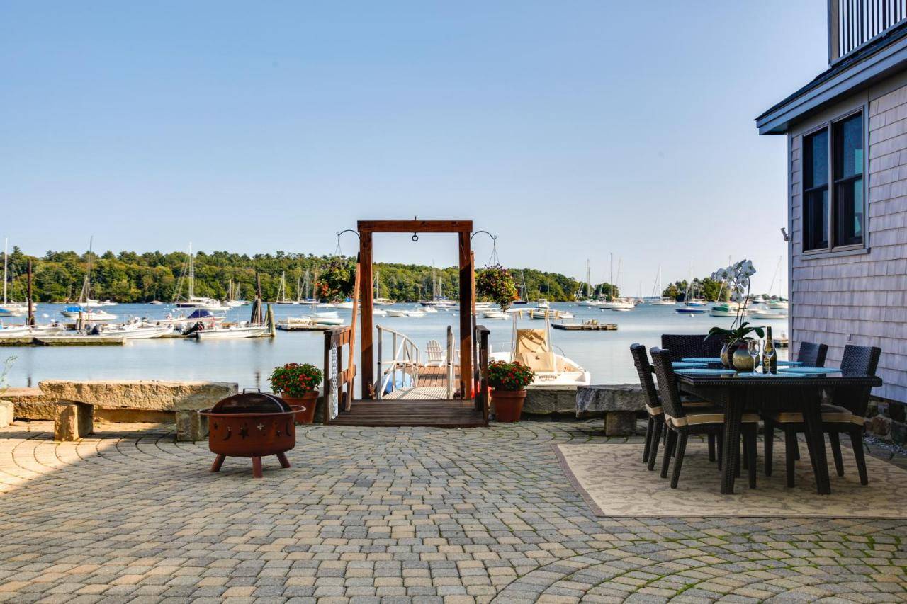 a patio with a table and chairs next to a marina at Osprey Cottage South Freeport Home on Casco Bay! in Freeport