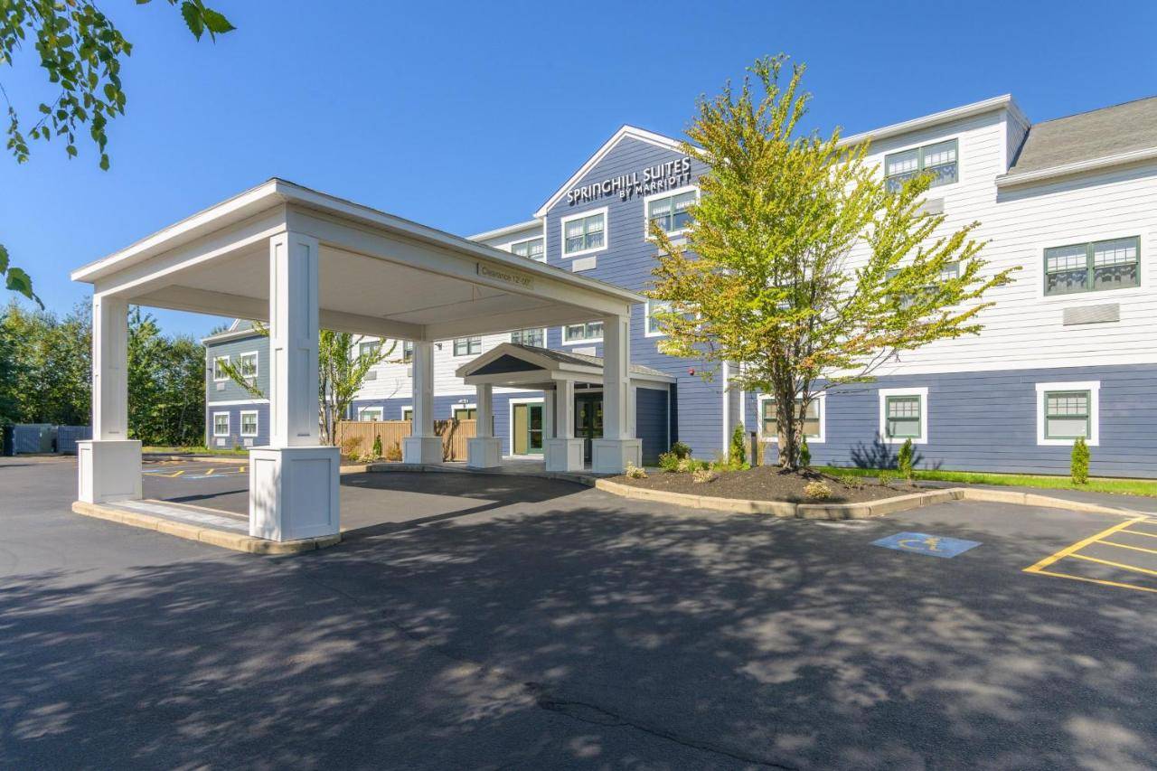 a large white building with a pavilion in front of it at SpringHill Suites by Marriott Freeport Brunswick in Freeport