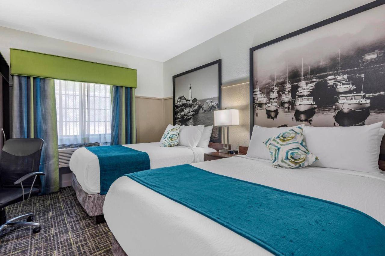 a hotel room with two beds and a window at The Freeport Hotel, an Ascend Collection Hotel in Freeport