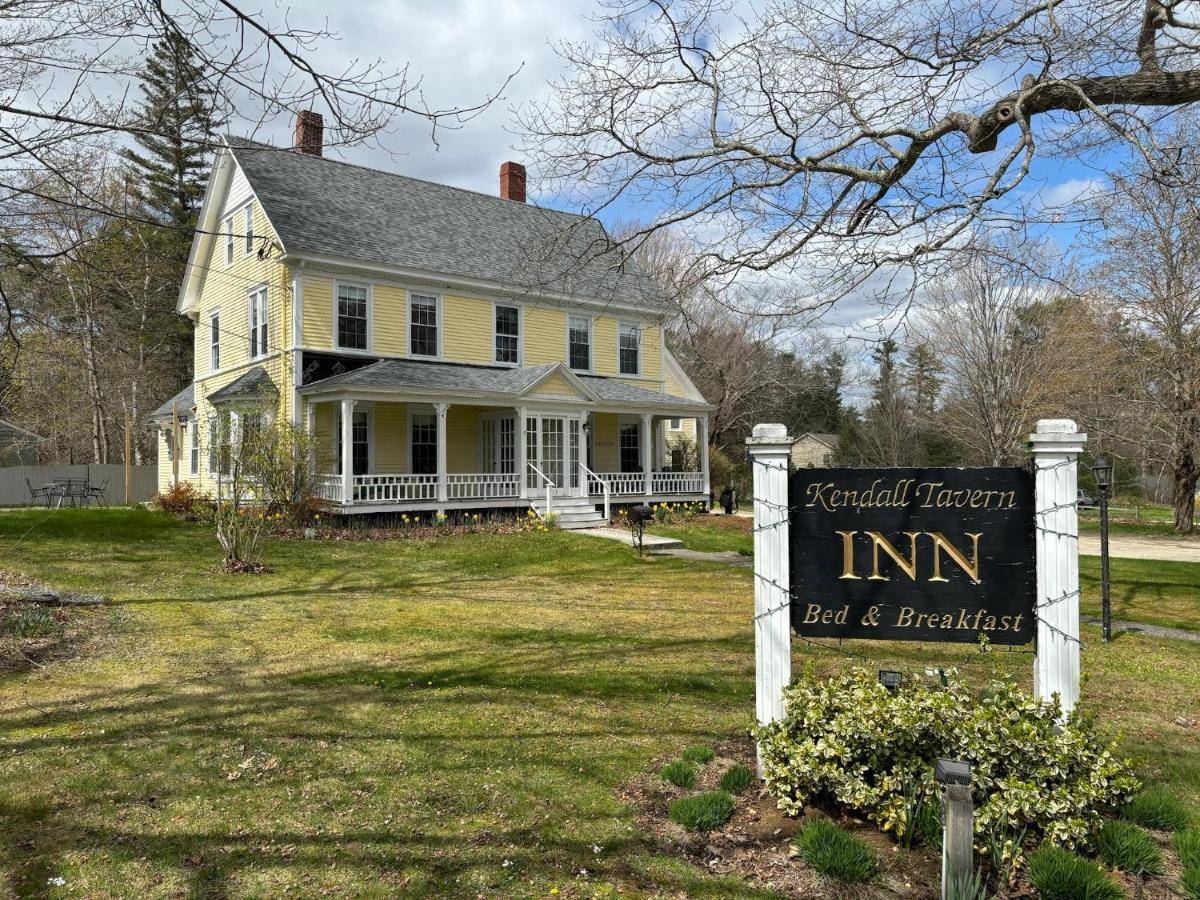 an inn sign in front of a house at The Kendall Inn in Freeport