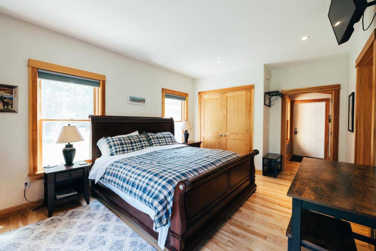 a bedroom with a bed and a desk and a window at Waterfront Private Apartment, 5 minutes from LLBean! in Freeport