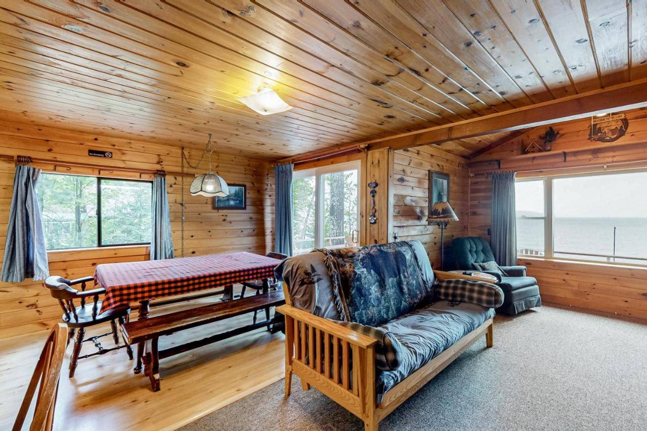 a living room with a couch and a table at Lakefront Cabin and Cottages in Greenville
