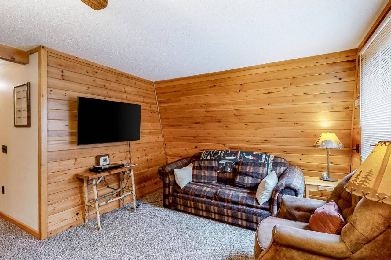 a living room with a couch and a flat screen tv at Lakeview Cabin in Greenville