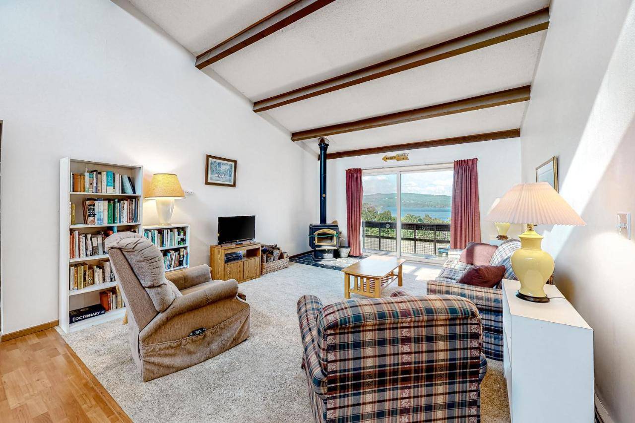 a living room with a couch and chairs and a tv at Lakeview Condo in Greenville