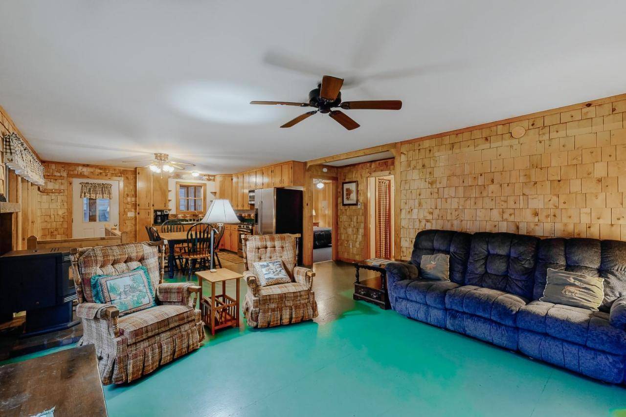 a living room with a couch and chairs and a ceiling fan at Owl's Nest in Greenville