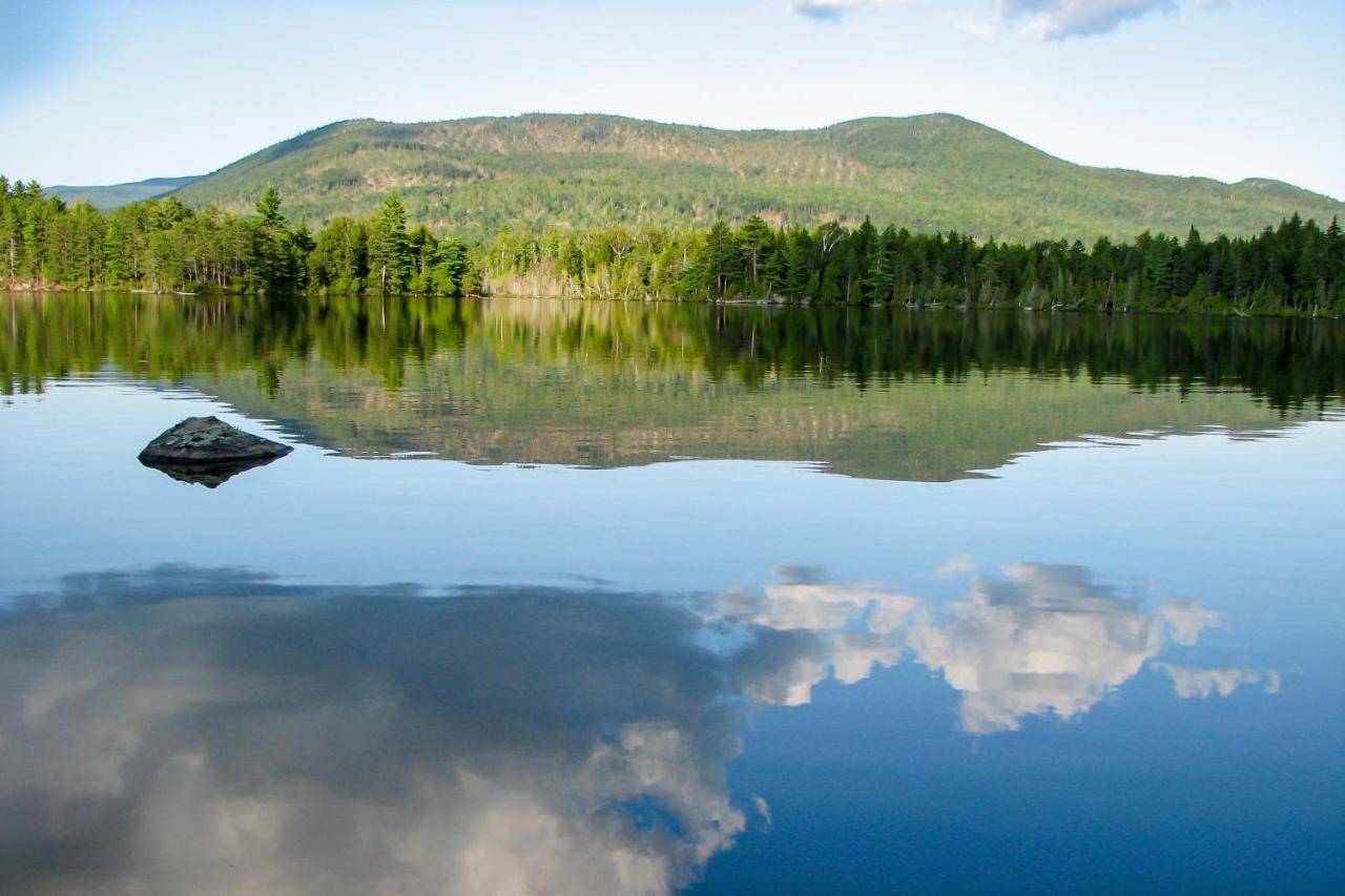 a lake with a reflection of the mountains in the water at Prong Mountain in Greenville