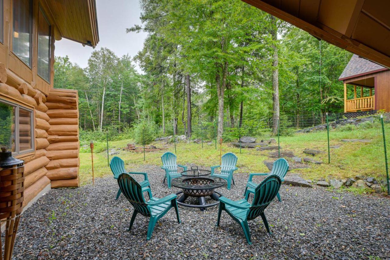 a group of chairs around a table in a yard at Secluded Greenville Cabin Walk to Moosehead Lake! in Greenville