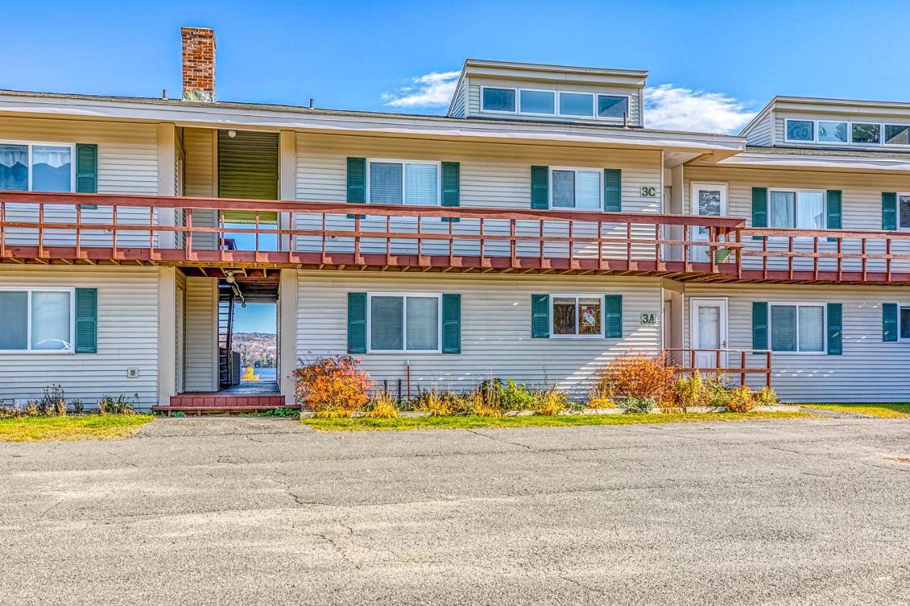 a house with a balcony on the side of it at Squaw Village Condo in Greenville
