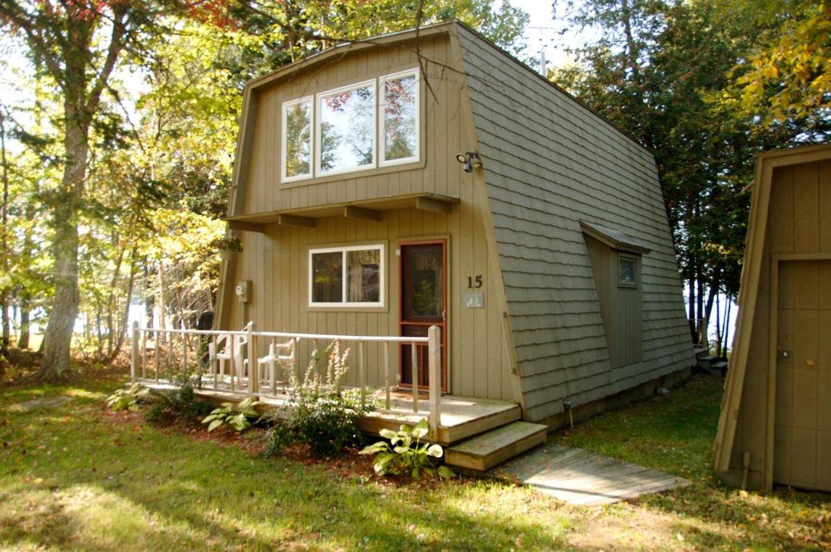 a tiny house with a porch and a door at Waterfront home on Moosehead Lake in Greenville