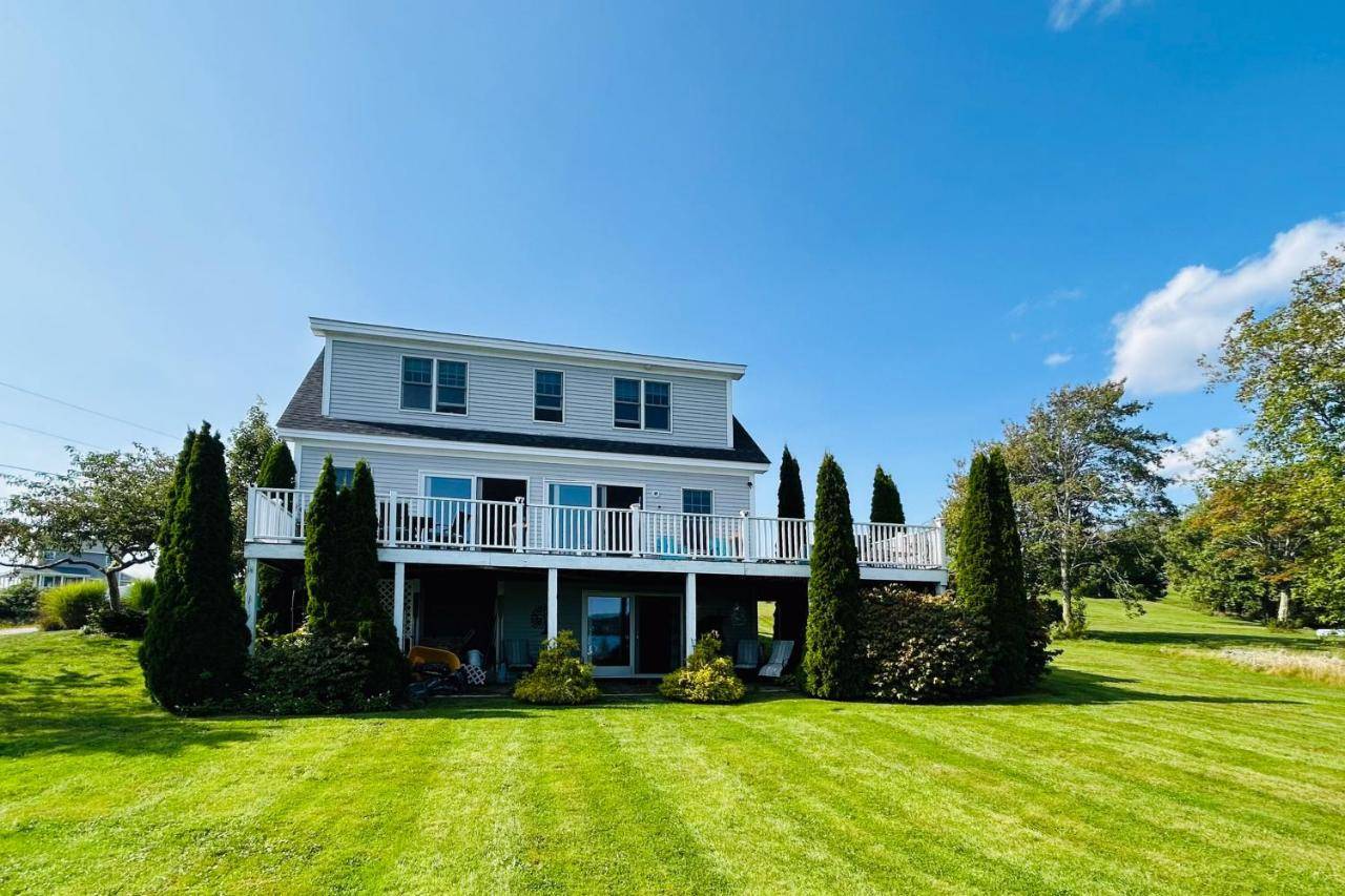 a large white house with a large yard at Clark Cove in Harpswell Center