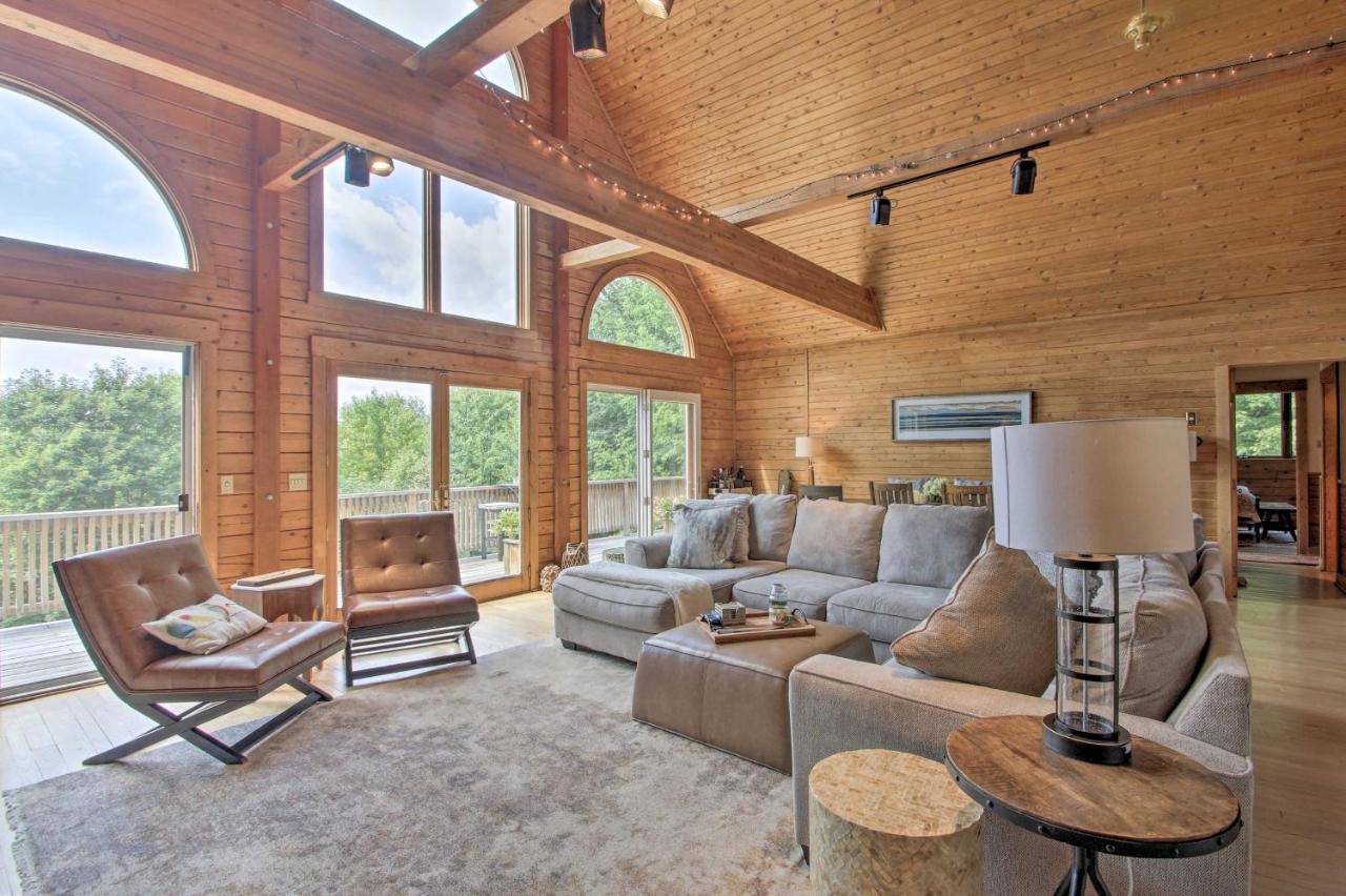 a living room with a couch and a table at Elegant and Quiet Maine Escape with Sauna and Deck! in Harrison