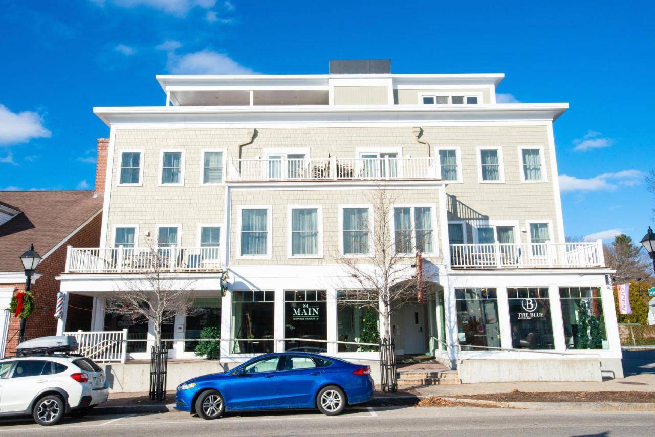 a white building with cars parked in front of it at 84 Main in Kennebunk