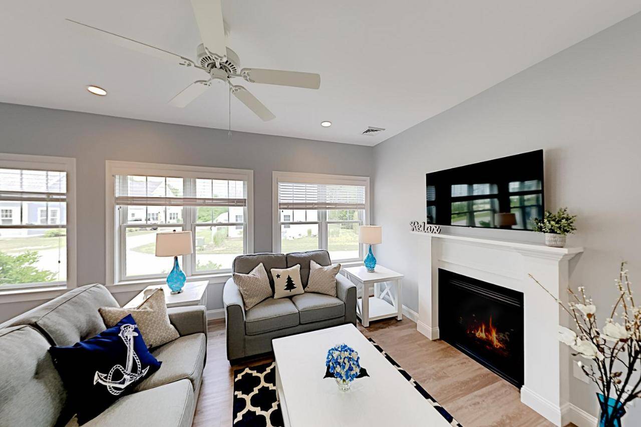 a living room with a couch and a fireplace at Cape Arundel House in Kennebunk
