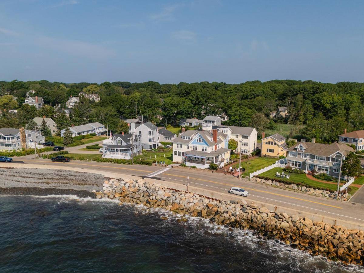 an aerial view of houses and a road next to the water at The Beach House Inn in Kennebunk