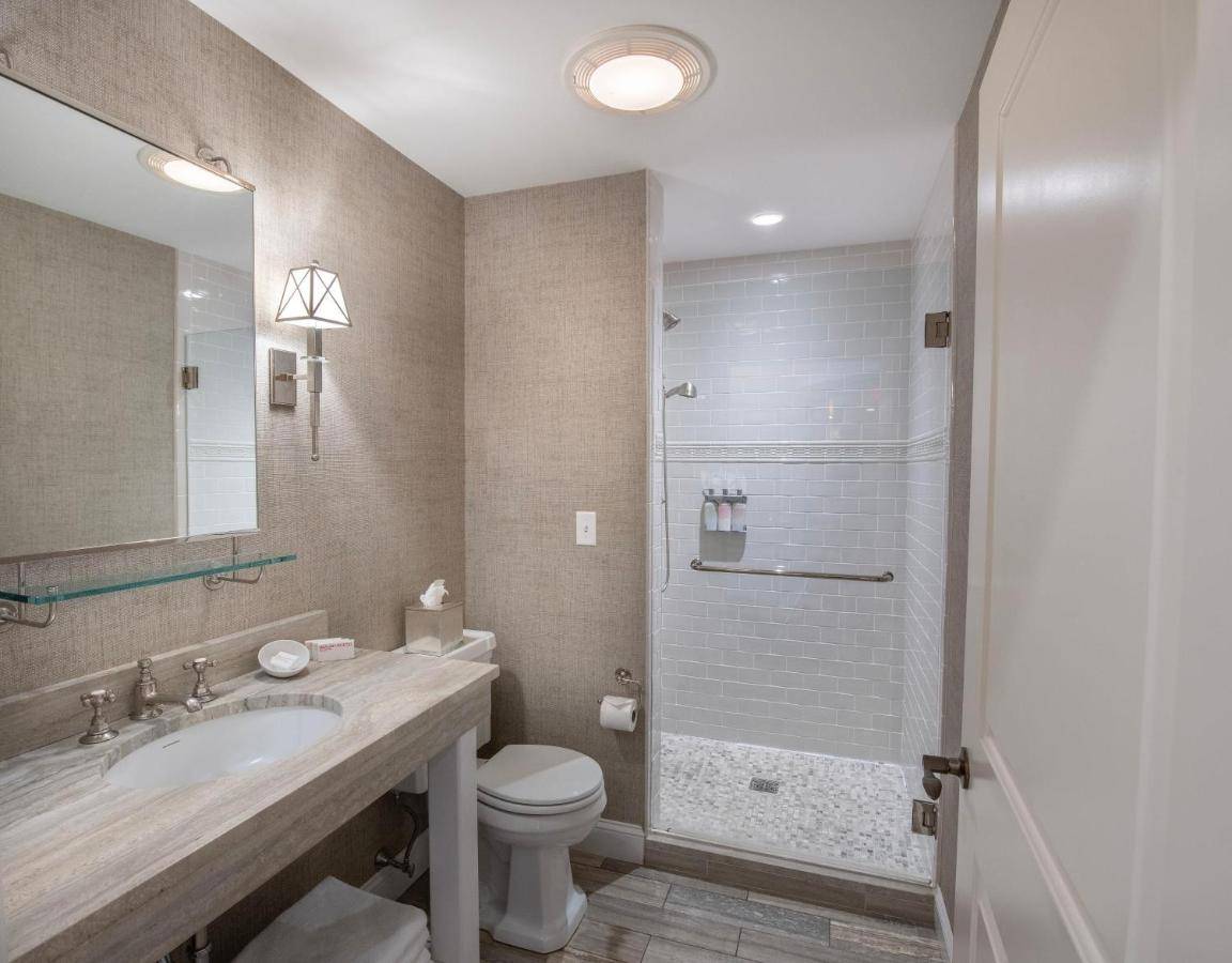 a bathroom with a sink and a toilet and a shower at The Grand Hotel in Kennebunk