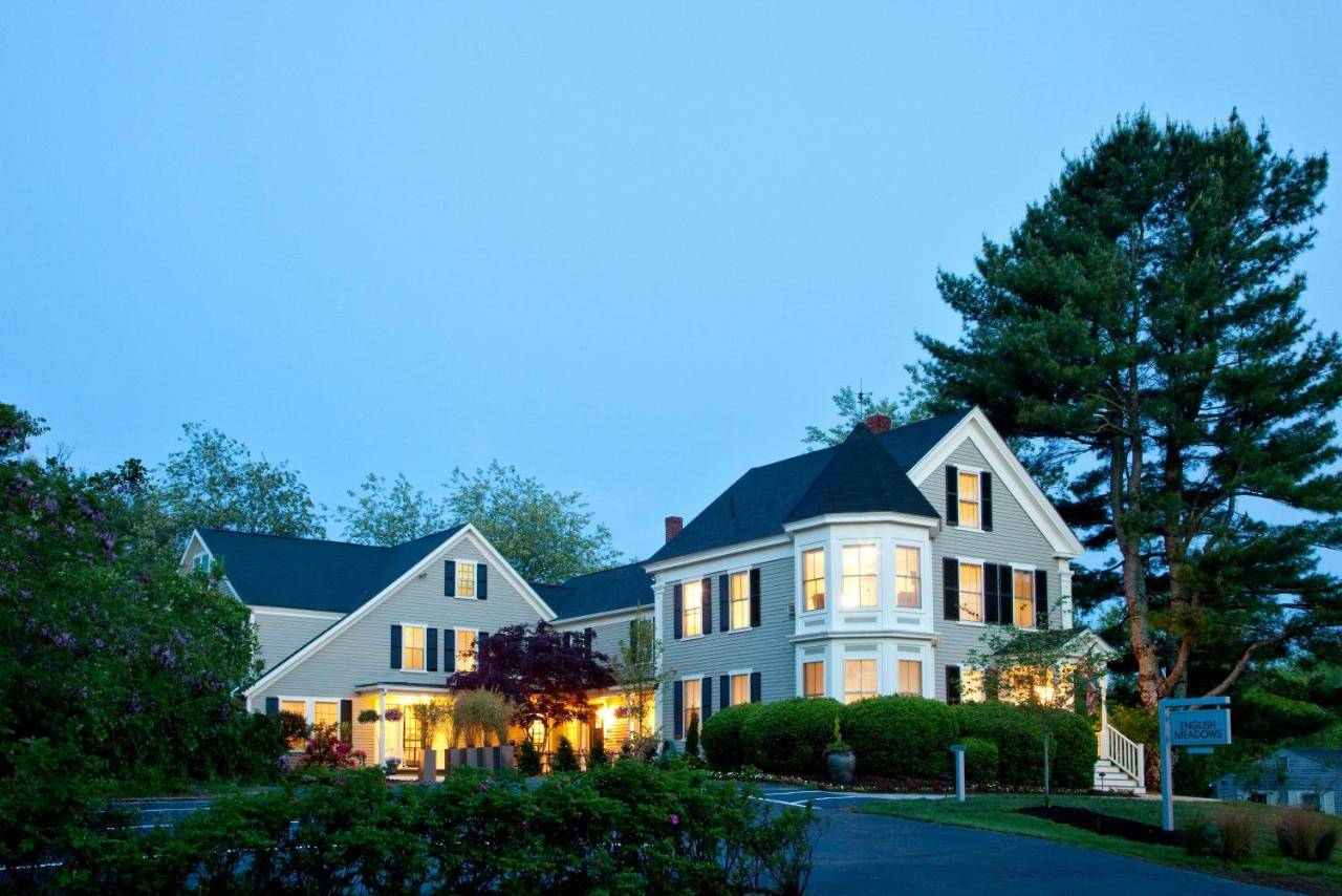 a large white house with its lights on at The Inn At English Meadows in Kennebunk