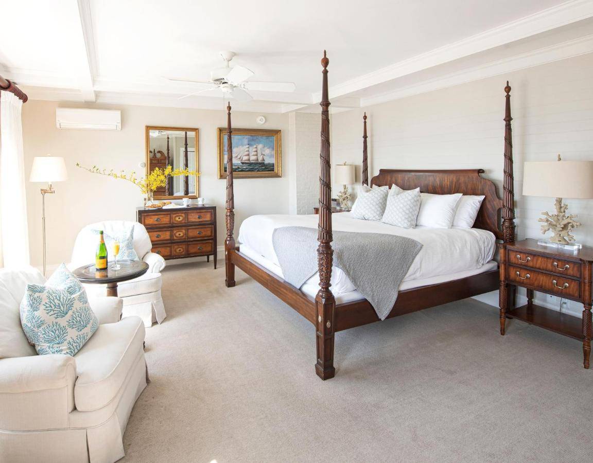 a large bedroom with a bed and a couch at Cape Arundel Inn and Resort in Kennebunkport