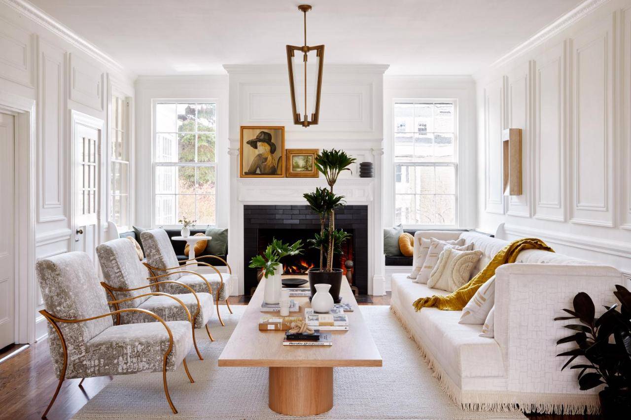 a living room with a white couch and a table at Kennebunkport Captains Collection in Kennebunkport