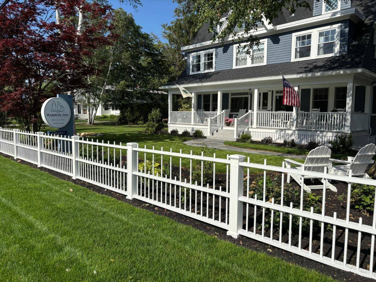 a white picket fence in front of a house at The Harbor Inn in Kennebunkport