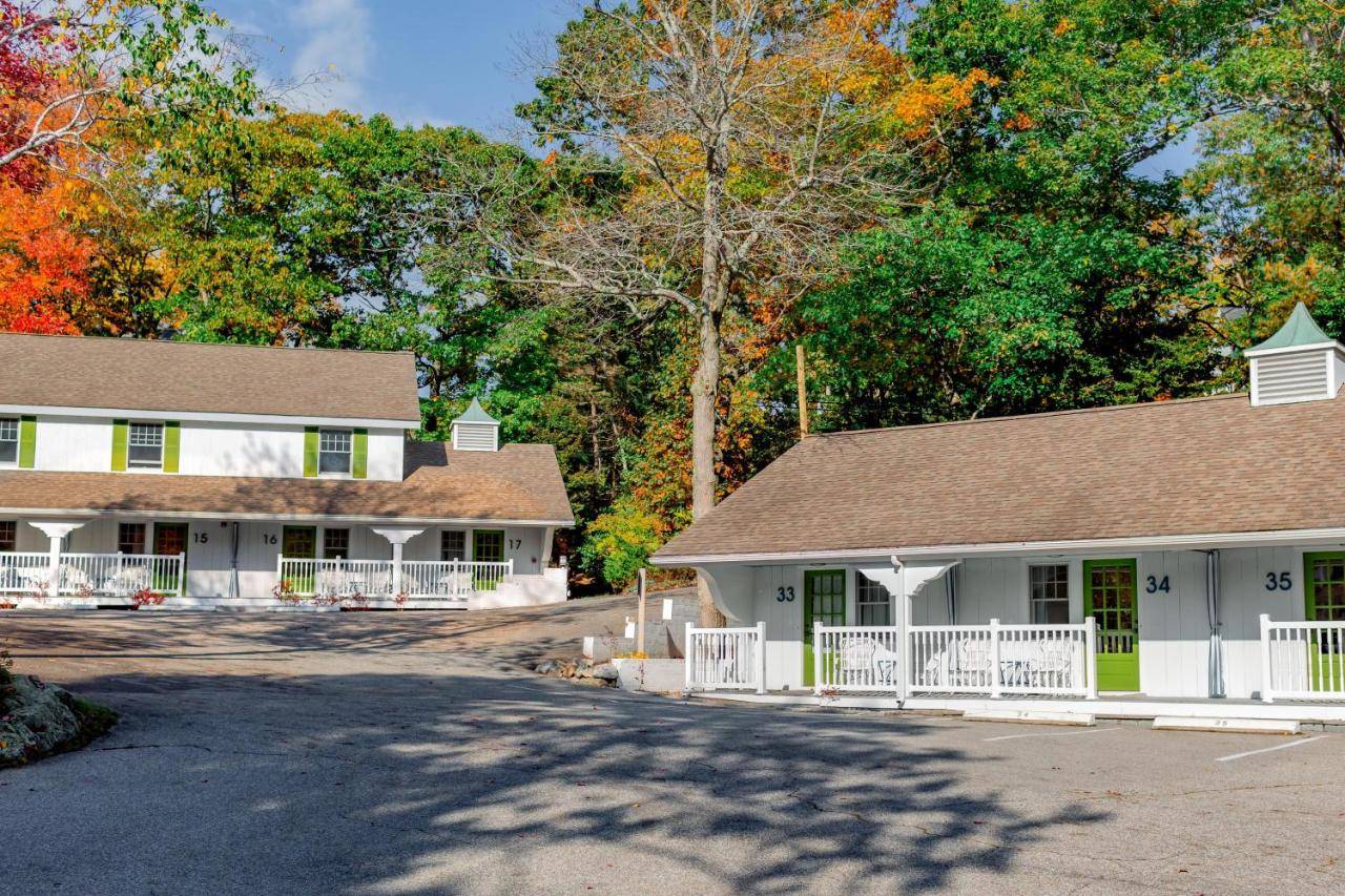 a white house with a brown roof at The Lodge on the Cove in Kennebunkport