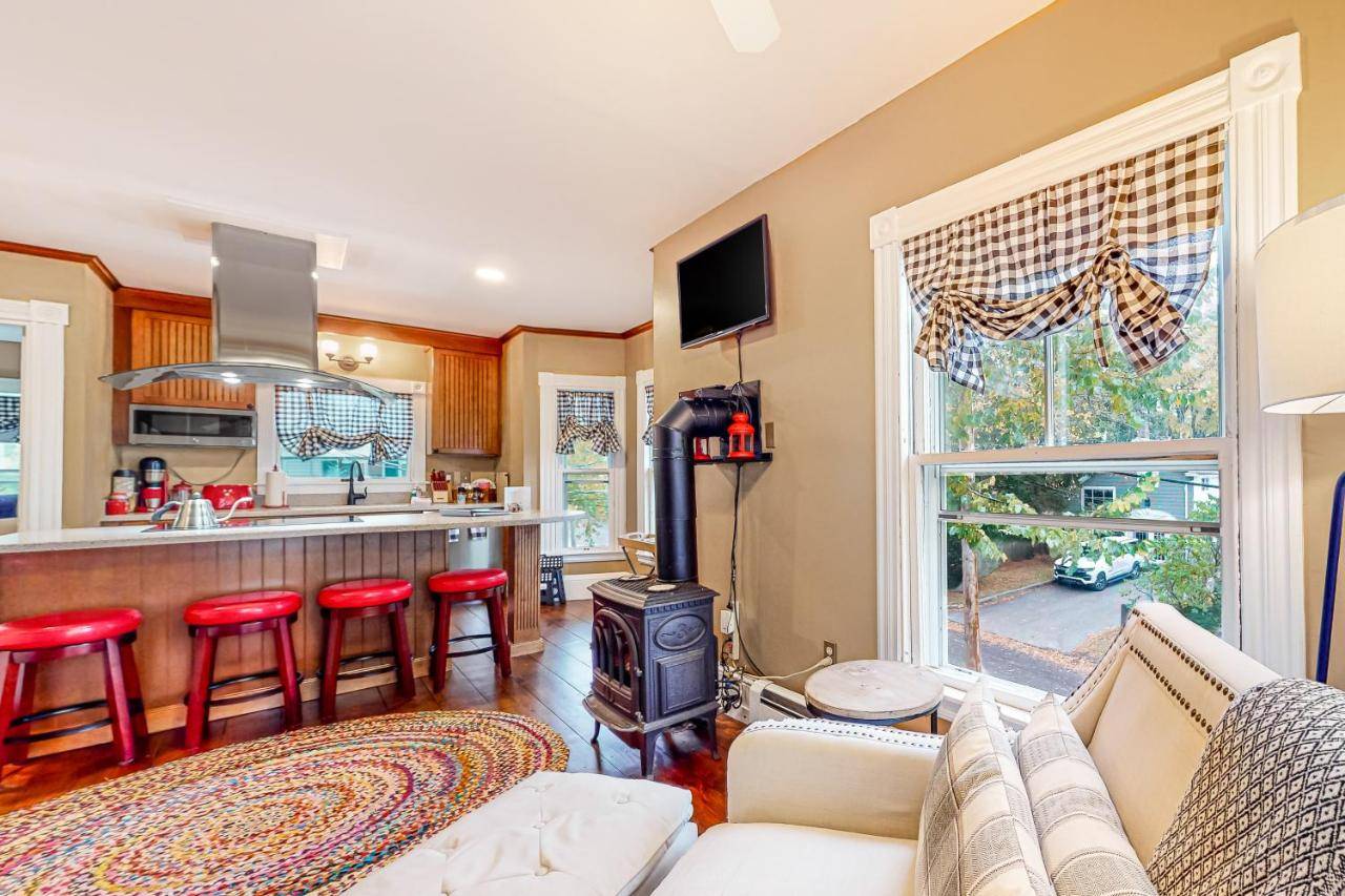 a living room with a couch and a stove at Pied-A-Terre in Kennebunkport