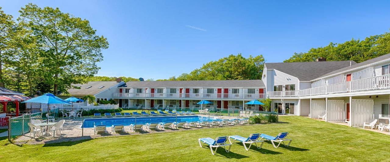 a resort with a pool and chairs and a building at Rhumb Line Resort in Kennebunkport
