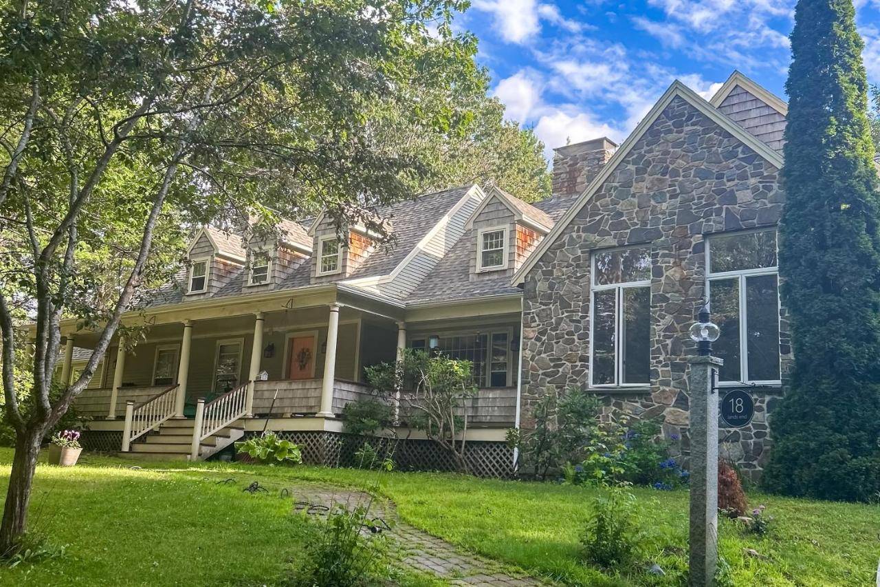 a home with a stone house at Rose Cottage at Lands End in Kennebunkport