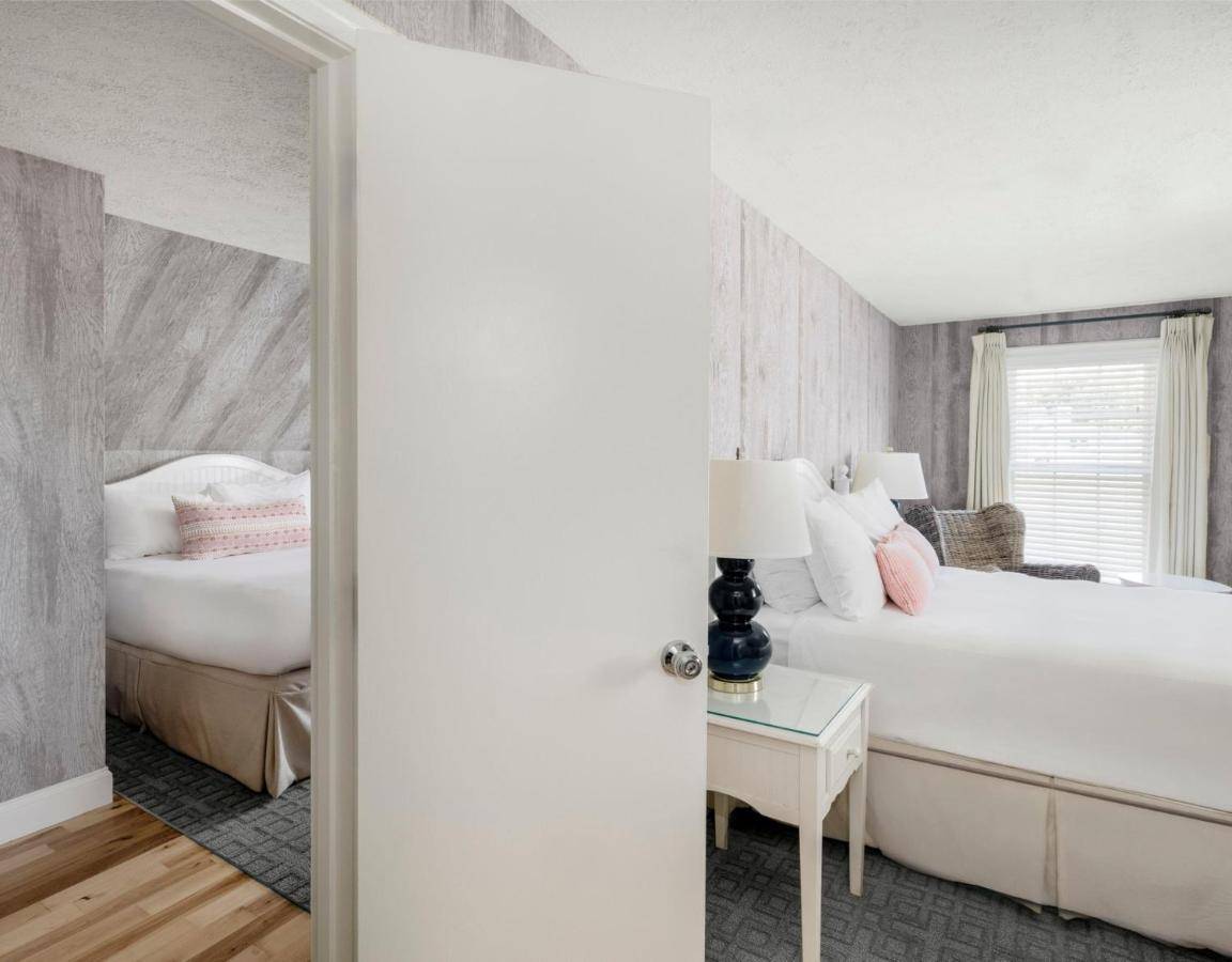 a bedroom with two beds and a window at The Boathouse in Kennebunkport