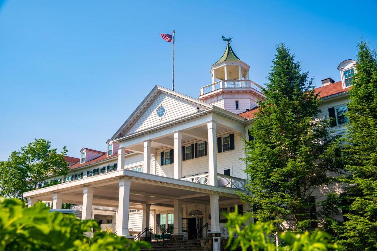 a white house with a tower on top of it at The Colony Hotel Kennebunkport in Kennebunkport
