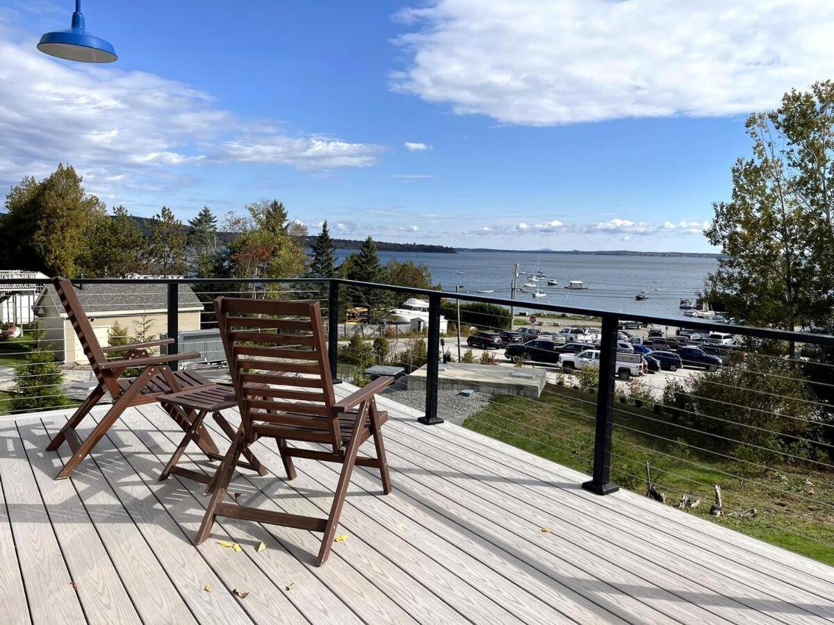 two chairs sitting on a deck with a view of the water at Eco-friendly studio - ocean views, close to beach in Lincolnville