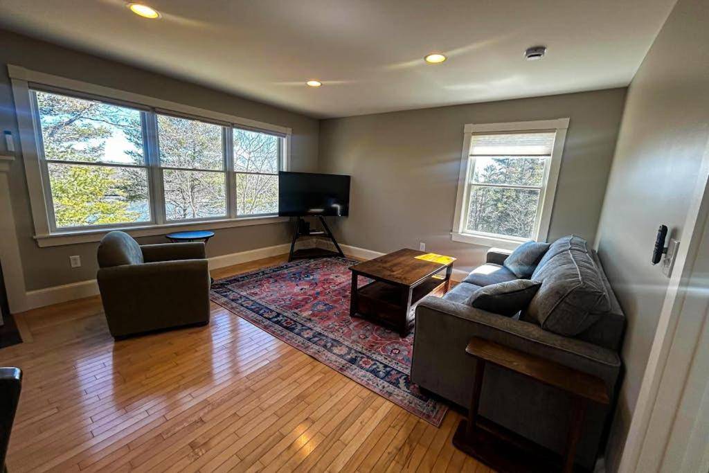 a living room with a couch and a flat screen tv at Barter Island Escape in Trevett