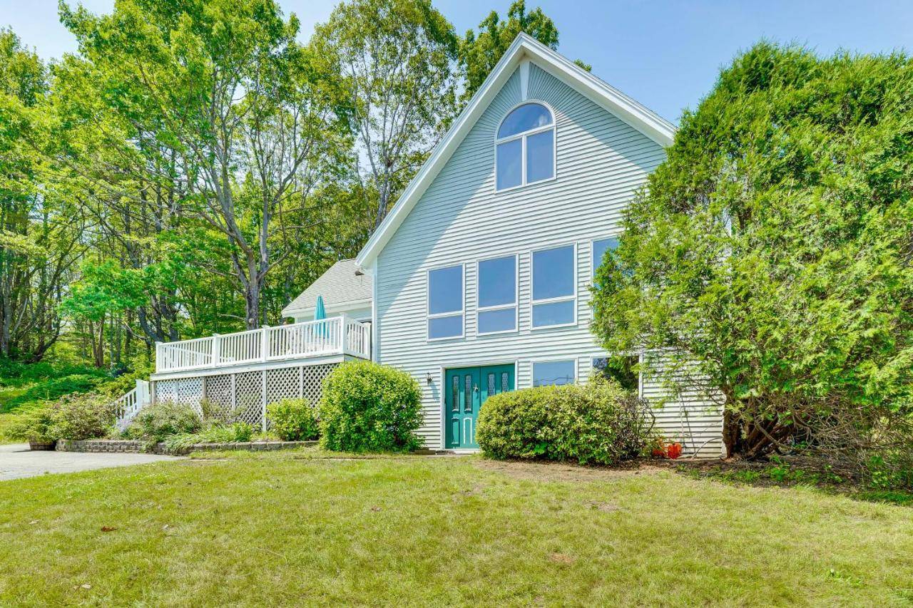 a blue house with a large yard at Boat Nearby Barters Island Home with Views in Trevett